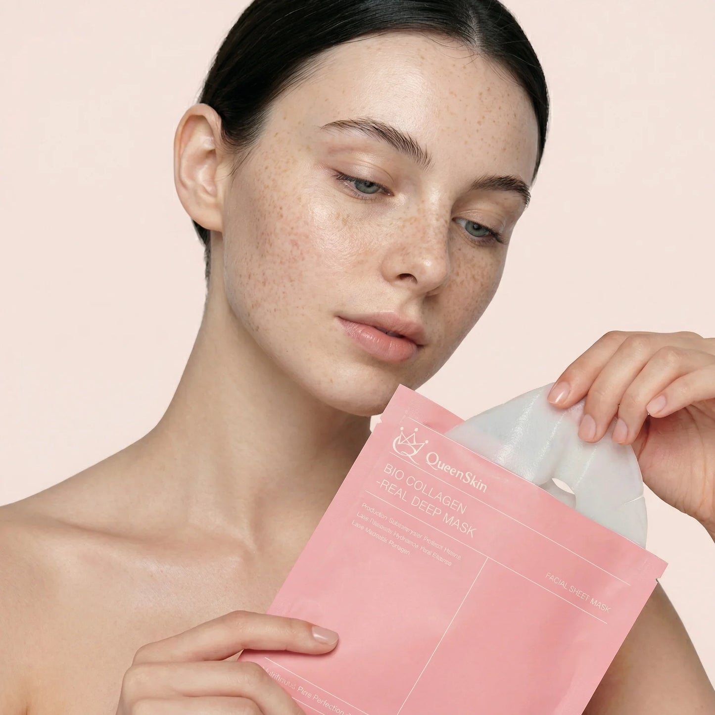 Woman holding QueenSkin Bio Collagen Real Deep Mask, skincare for wrinkles and dry skin