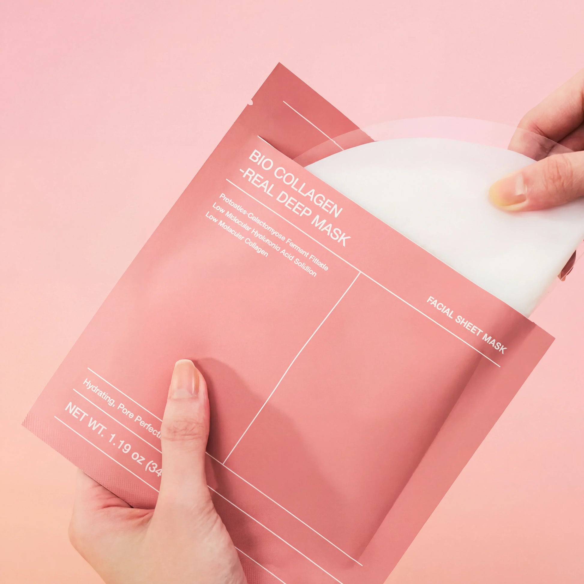 Hands opening QueenSkin Bio Collagen Real Deep Mask facial sheet mask on pink background