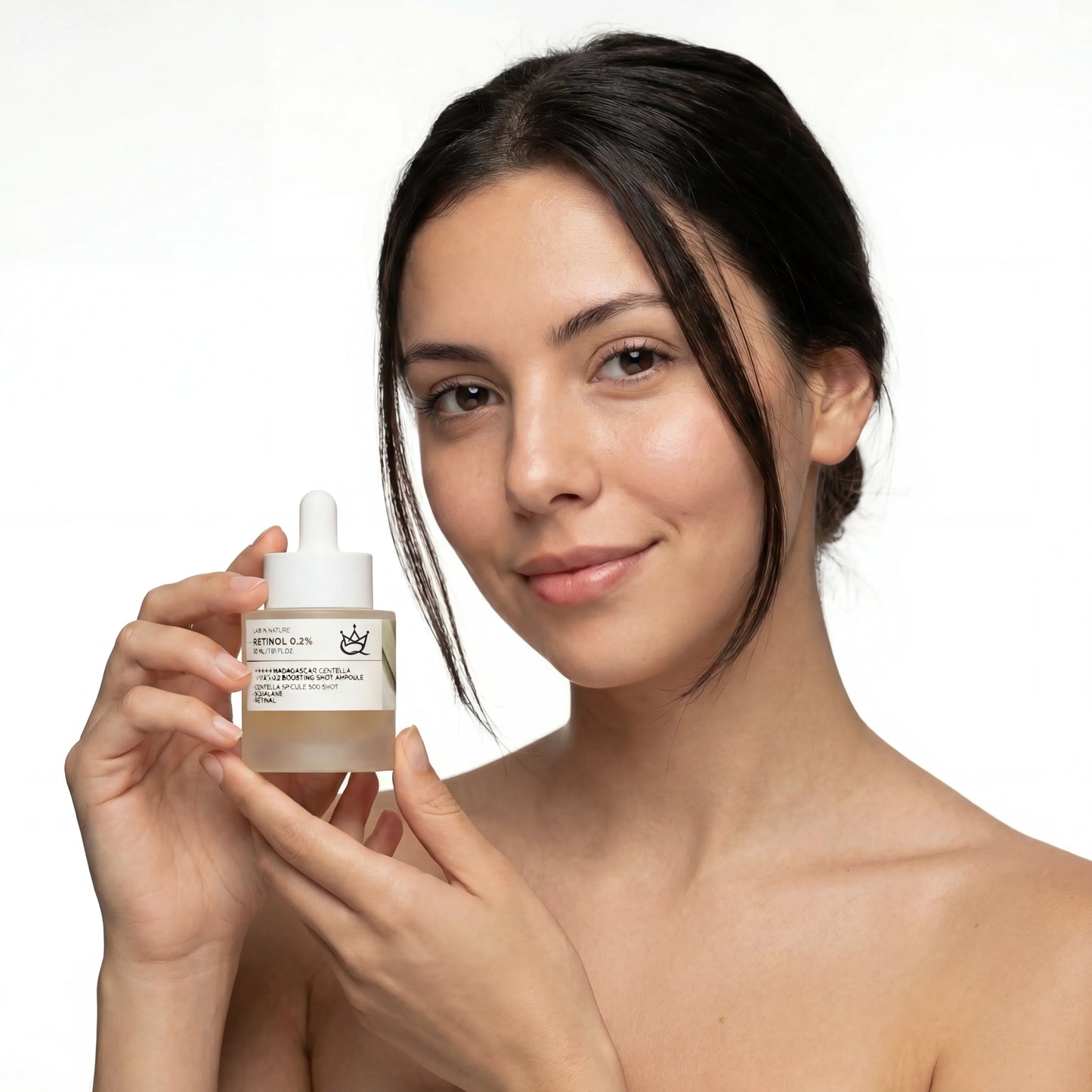 Woman with clear skin holding QueenSkin retinol serum bottle, promoting skincare product