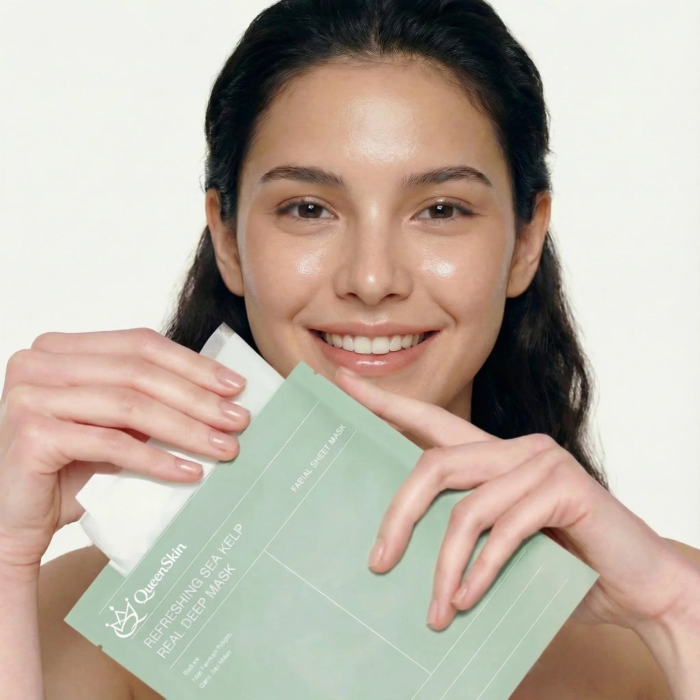 Smiling woman holding QueenSkin Refreshing Sea Kelp Real Deep Mask facial sheet mask
